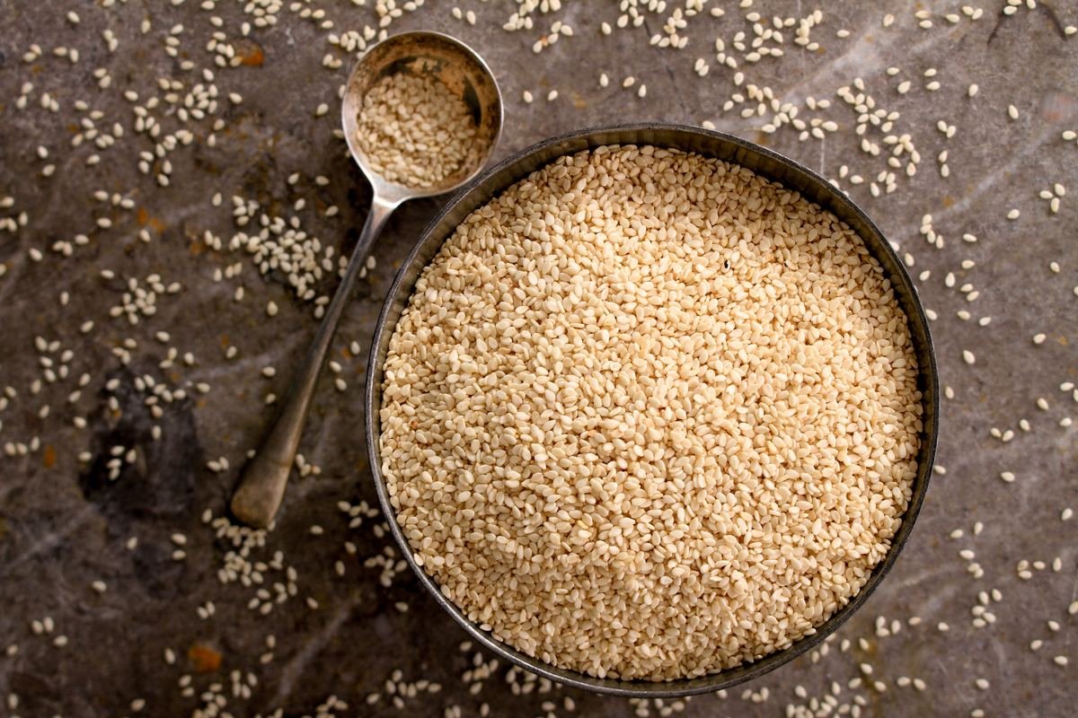 Bowl of sesame seeds with a spoon