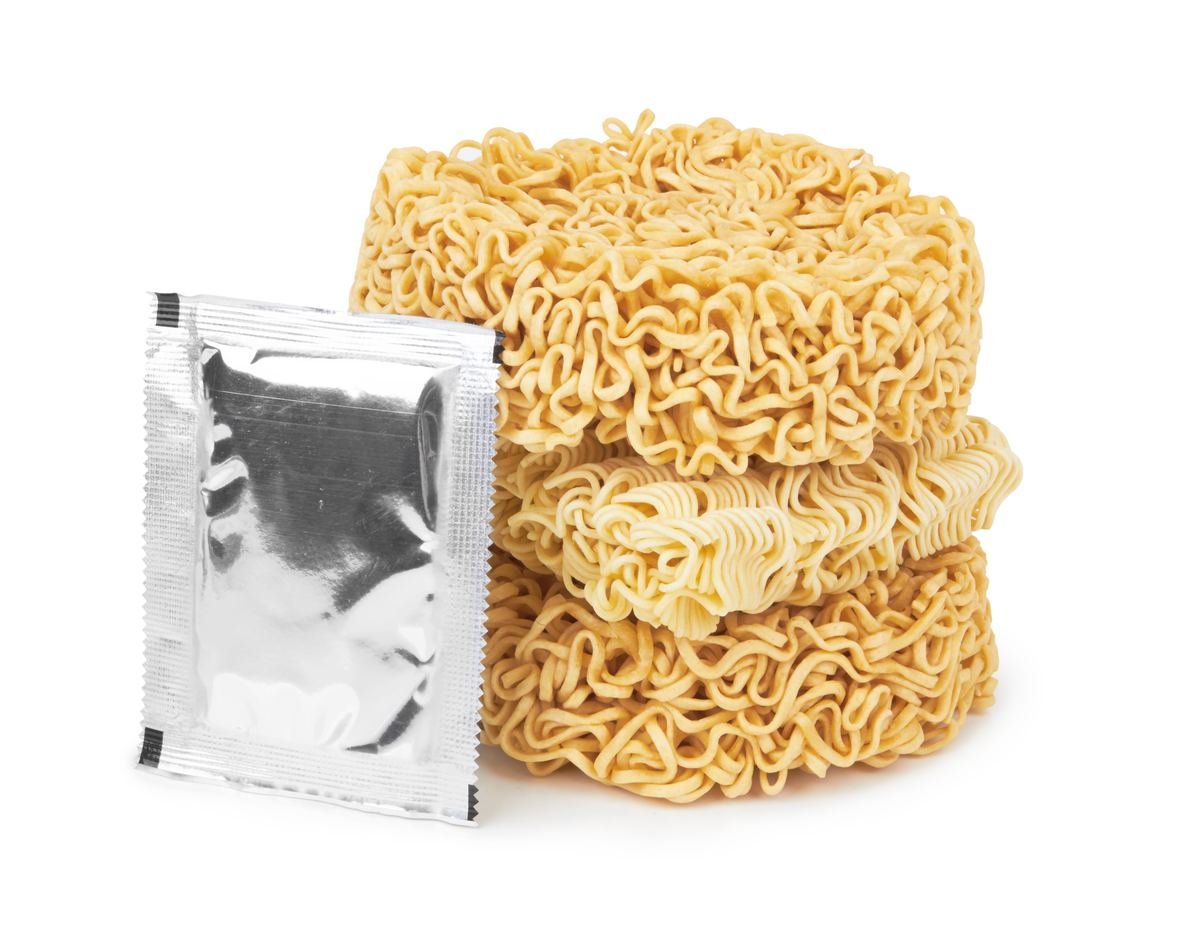 Stack of instant noodle cakes with a foil seasoning packet