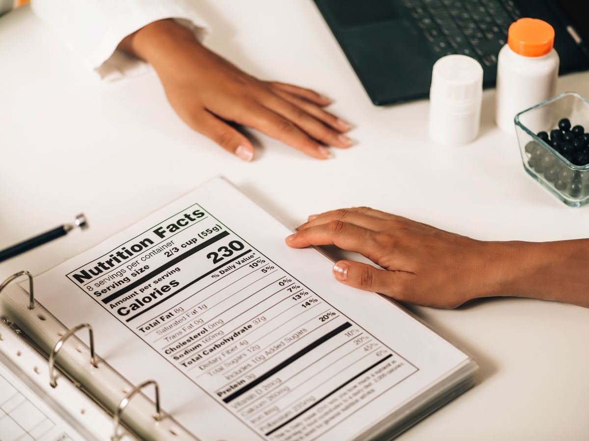 Nutrition Facts label in a binder being reviewed at a desk
