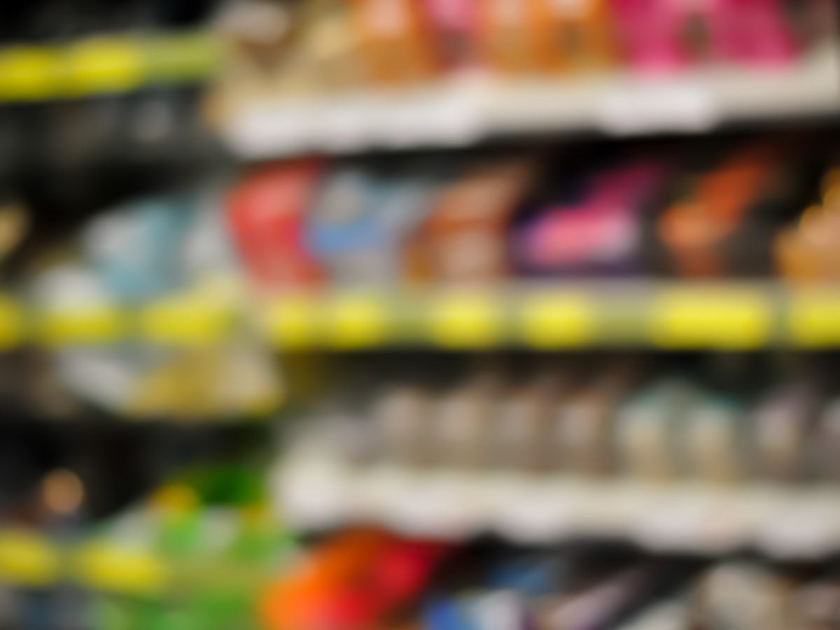 Packaged food products lining a supermarket aisle