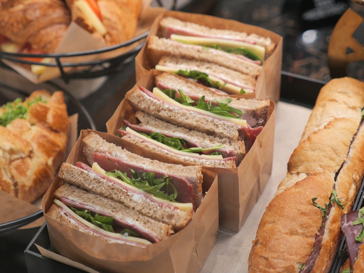 Pre-packed sandwiches and pastries on display at a food-to-go counter