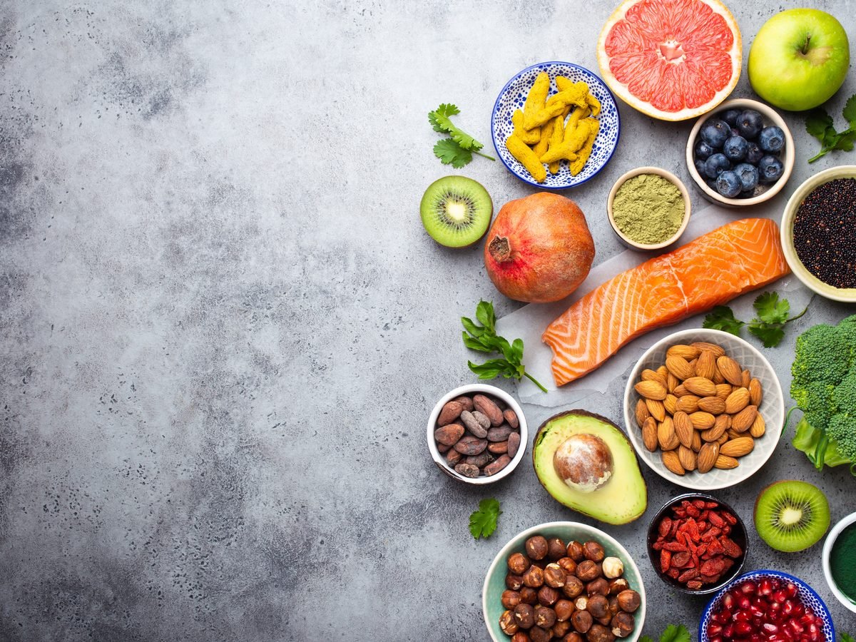 Fresh produce, fish, nuts and grains arranged on a grey surface